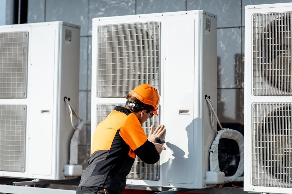 workman-installing-outdoor-unit-of-the-air-conditioner